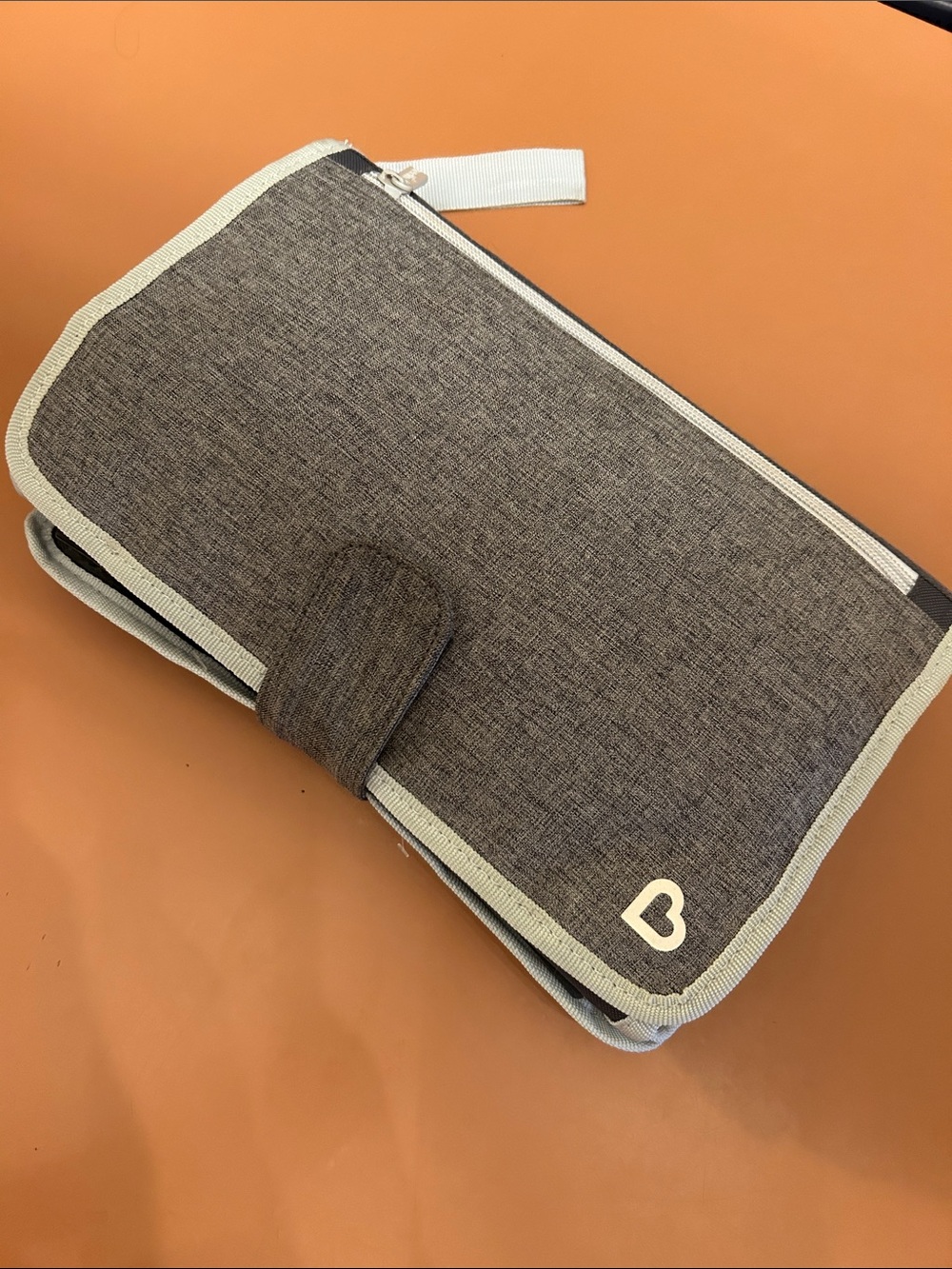 Compact Diaper Holder with Changing Pad. Quick for on the go!